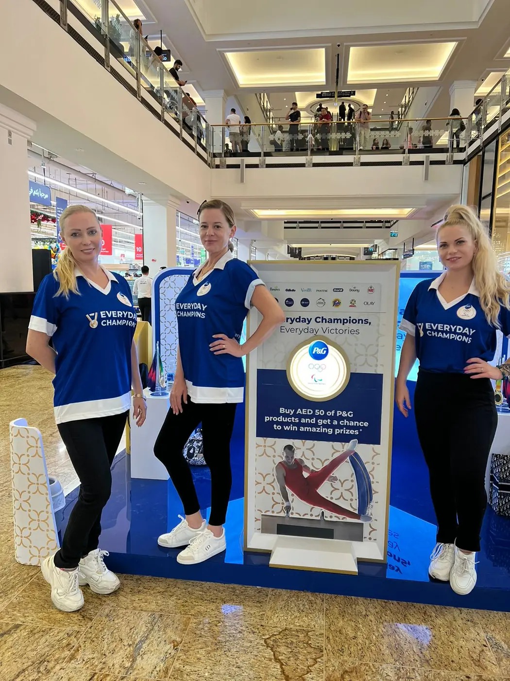 Promoters at the Olympics-themed mall kiosk (1)